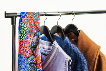 Wall Mural - Row of woman fashion clothes of different colors clothing on hangers, Hanging clothes suit colorful or closet rack