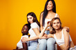 © iordani - diverse multi nation girls group, teenage friends company cheerful having fun, happy smiling, cute posing on yellow background, lifestyle people concept, african-american, asian and caucasian