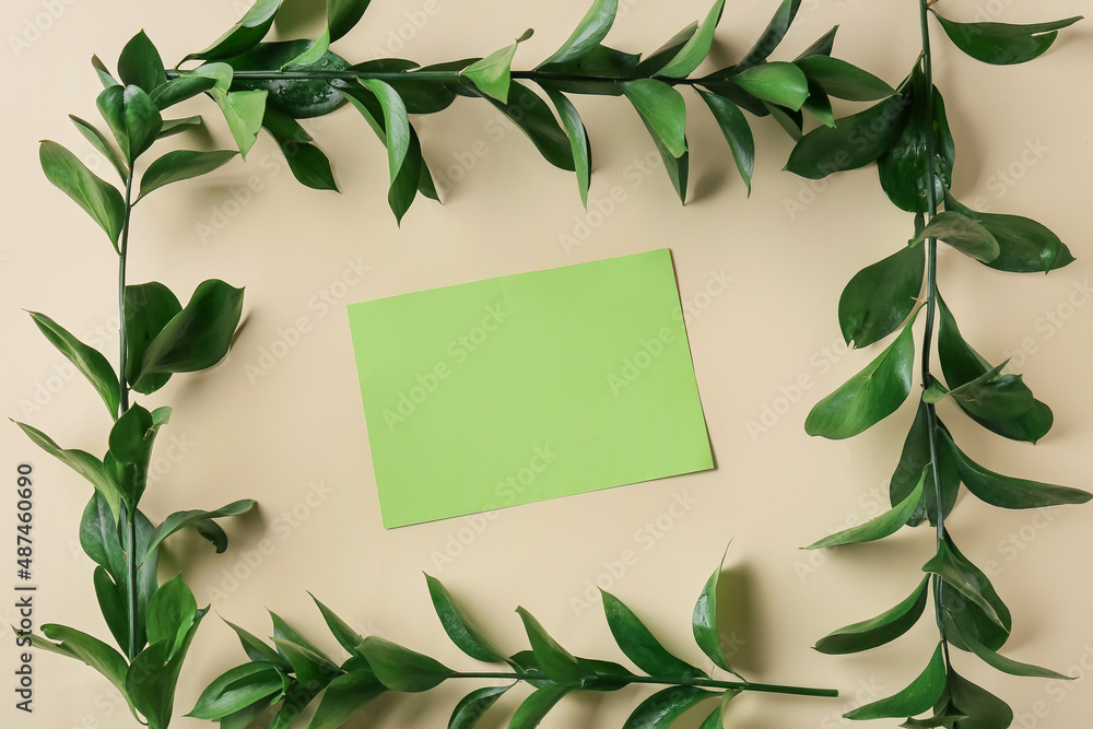 Composition with blank card and plant branches on color background