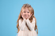 © New Africa - Cute girl in diadem on light blue background. Little princess
