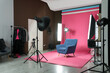 © New Africa - Stylish blue armchair in photo studio with professional equipment
