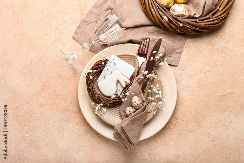 Stylish table setting with Easter cookie on beige background