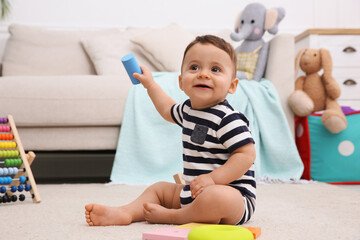 Sticker - Cute baby boy playing with toys on floor at home