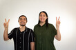 © Antonio Tanaka - young Hispanic heterosexual couple happy and smiling on a white background