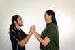 © Antonio Tanaka - young Hispanic heterosexual couple happy and smiling on a white background