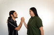 © Antonio Tanaka - young Hispanic heterosexual couple happy and smiling on a white background