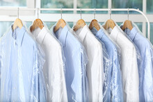 Rack With Clean Shirts In Plastic Bags After Dry-cleaning