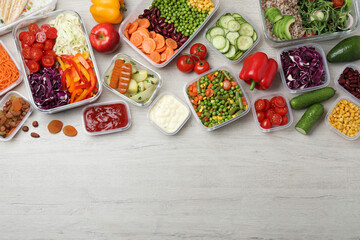 Set of containers with fresh food on white wooden table, flat lay. Space for text