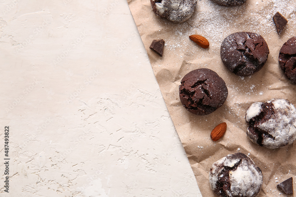 Parchment with chocolate brownie cookies on light background, closeup