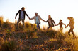 © Mariusz S/peopleimages.com - Working together to reach greater heights. Shot of a happy family holding hands on a morning walk together.