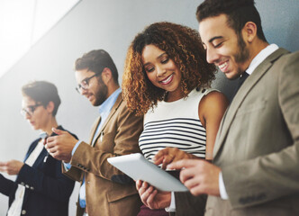 Aufkleber - Digitally engaging their customers. Shot of a group of businesspeople using wireless technology together while standing in a row.