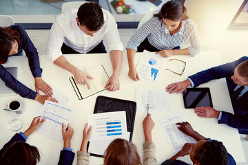 Wall Mural - Staying on top of business. High angle shot of a group of businesspeople having a meeting in an office.