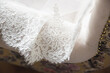 © VASILII CHAPLIEV - lace hem white wedding dress on background of the floor