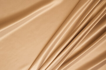 Beautiful elegant wavy beige satin silk luxury cloth fabric with monochrome background design. 
