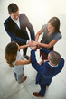 © Camerene Pendl/peopleimages.com - Teamwork is one of the greatest components of success. High angle shot of a group of businesspeople joining their hands together in unity.
