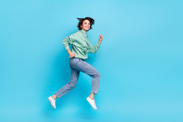 Wall Mural - Full body profile photo of cool young brunette lady run wear pullover jeans shoes isolated on blue background