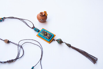 Wall Mural - Ethnic teal brown long pendant . Boho style still life.