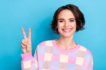 Poster - Photo of young pretty woman cheerful show fingers peace cool v-symbol isolated over blue color background