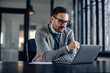 © bnenin - Concentrated caucasian businessman, reading his e-mails, on the laptop.
