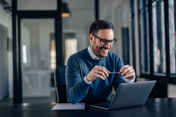 lovely caucasian office worker, playing with his plan, while coming up with ideas.