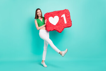 Wall Mural - Full body photo of young charming girl have fun hold paper pinata ads comment popular isolated over teal color background