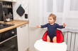 © яна винникова - adorable little girl is standing in a feeding chair and waiting for food