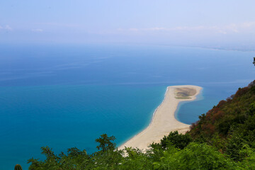 Wall Mural - High angle view of the sand tong of Punta Marinello nature reserve with horizon over the sea