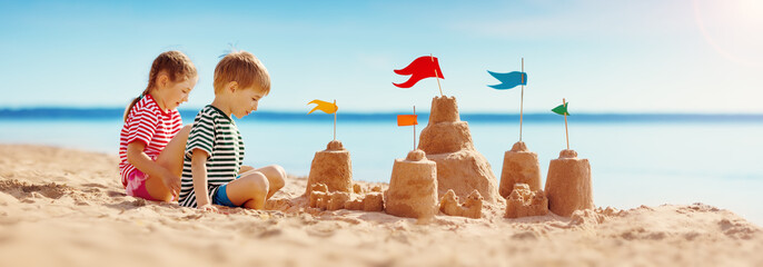 Boy and girl playing on the beach on summer holidays.