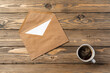 © fotofabrika - Vintage envelope with empty card, pen on wooden table top view