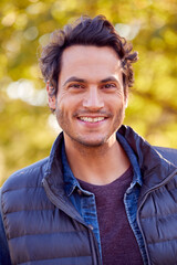 Wall Mural - Portrait Of Smiling Man Outdoors Relaxing In Autumn Park