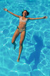 © Impact Photography - Woman floating on water while on summer vacation