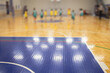View of basketball court hall indoor venue with junior teenage school team playing in the background, basketball match game on arena stadium, team is blurred with copy space