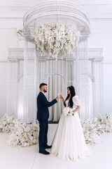 Wall Mural - Newlyweds swear allegiance to each other. Celebration in the White Hall. Congratulations to the young. Significant day.