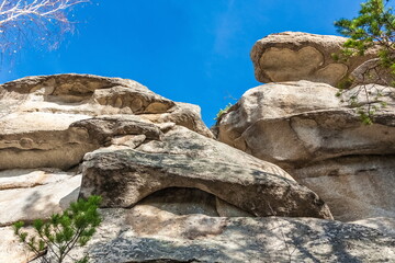 Autumn landscape with trees and rocks on top of a mountain against the sky