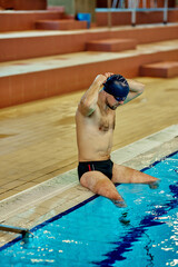 Wall Mural - Male swimmer preparing for swimming