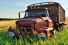 Abandoned Vintage And Rusty Truck In A Field On A Sunny Day