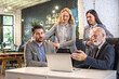 © Bojan - Businessman explaining male and female investors over laptop in office