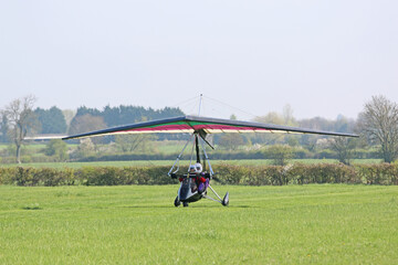 Poster - 	
Ultralight airplane taxiing on a farm strip	