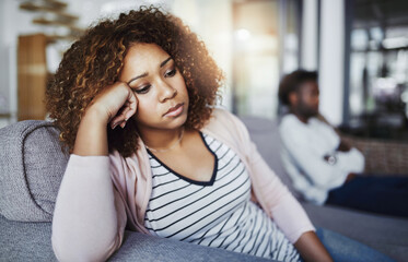 Sticker - Shes in no mood to even think about reconciling. Shot of a young woman looking despondent after having a fight with her boyfriend at home.