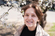 © Мар'ян Філь - Young teen girl with a charming smile near a flowering tree in spring, the girl is happy that she has braces on her teeth, orthodontic concept. Focus on the teeth and braces of the girl