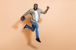 © deagreez - Full body profile photo of impressed young beard guy run hold laptop wear shirt jeans footwear isolated on beige background