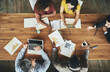 © Lyndon Stratford/peopleimages.com - Birds-eye view of business. High angle shot of a team of businesspeople meeting around the boardroom table in the office.
