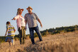 © BalanceFormCreative - Grandparents with the grandson. They're playing on the meadow and joying in sunset.