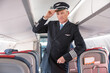 © Kostiantyn - Man airline captain standing in passenger airplane salon