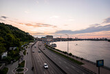 Fototapeta Dziecięca - Kyiv, Ukraine. July 20, 2021. Aerial view of kiev cityscape with cruise port at dnieper river and cars moving on highway motorway