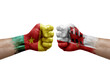 Two hands punch to each others on white background. Country flags painted fists, conflict crisis concept between cameroon and gibraltar