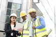 © Wongsakorn - Group of Engineer Worker Wearing Safety Uniform and Hard Hat Uses Tablet Computer. Happy Successful.