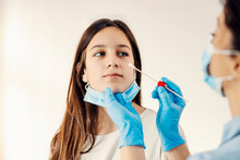 A Girl Getting Tested On Covid 19 With PCR Test/ Cotton Swab. 