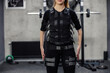 Electrical muscle stimulation equipment on a fit woman.