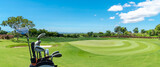 The Golf club bag for golfer training and play in game with golf course background , green tree sun rays.
